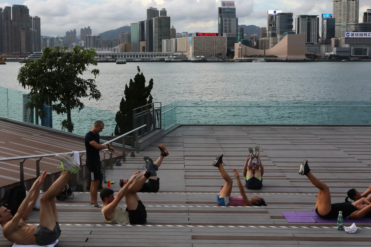 Uрупа людей займається спортом із дотриманням соціальної дистанції надворі, Гонконг: фото K.Y. Cheng