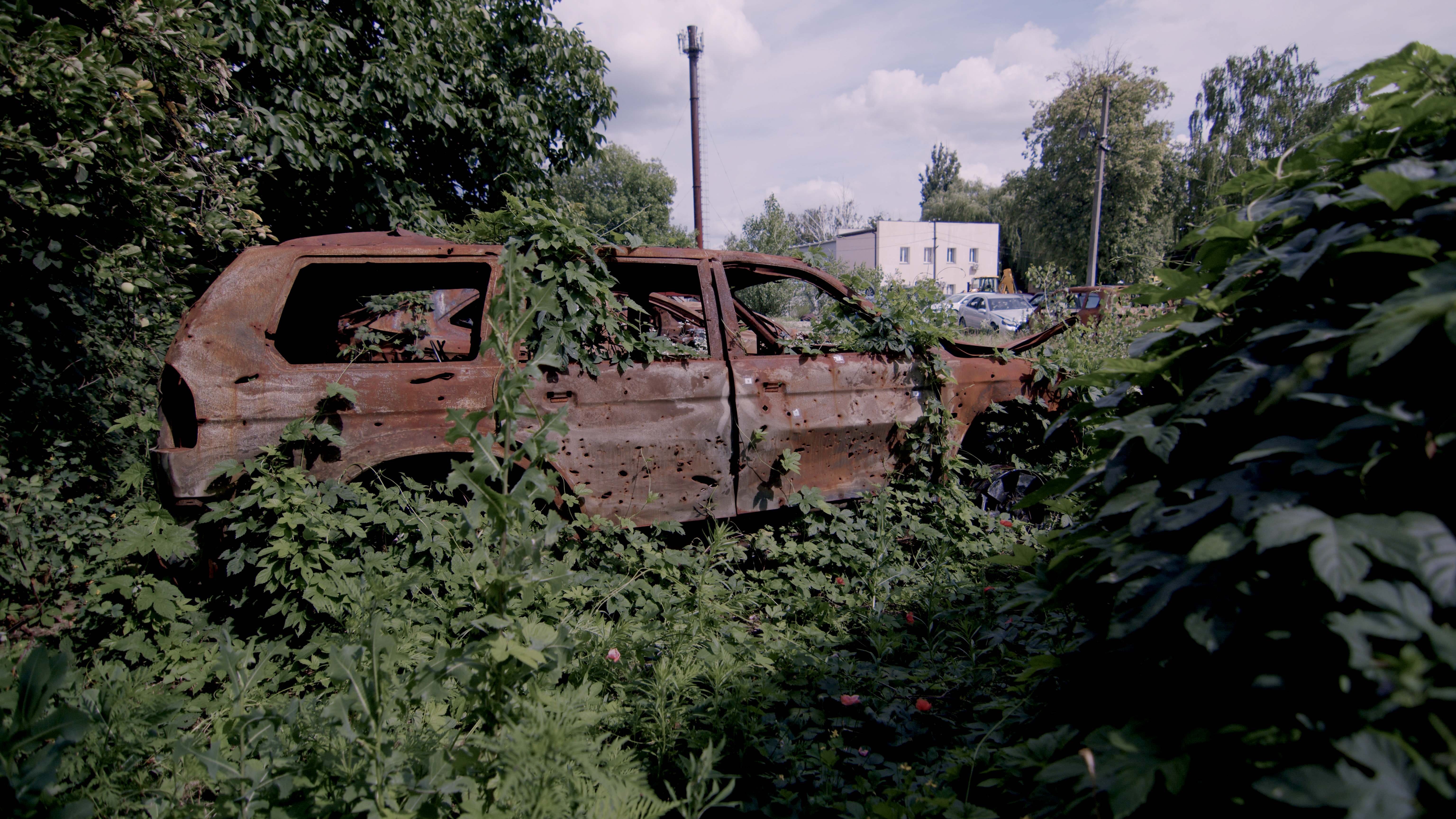 The village of Dmytrivka, a car dump. The remains of a Mitsubishi Pajero Sport that was shot up on the Zhytomyr highway. Photo: DENOTAT documentary group, Roman Synchuk