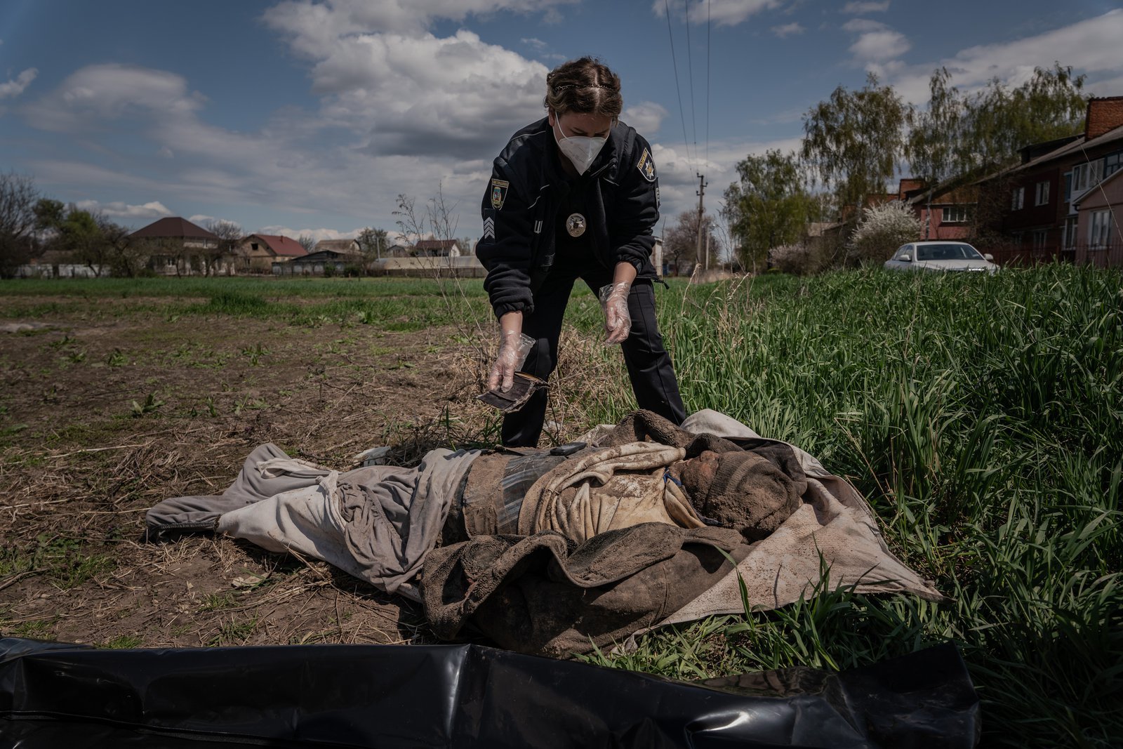 Policewoman Tetyana examines a body. The man is identified by the surname on the bank card